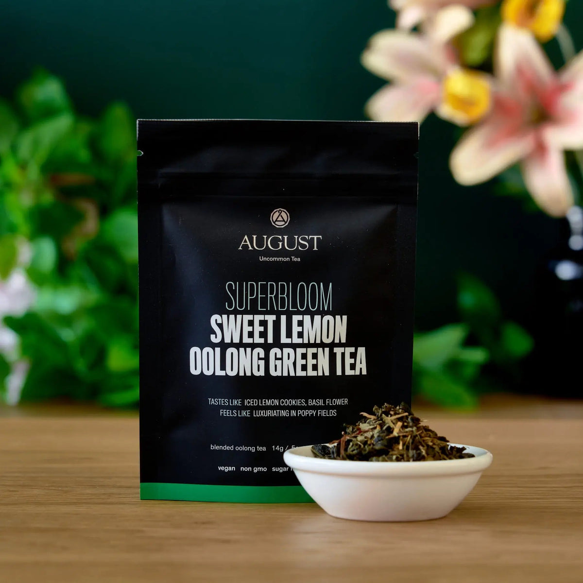 Four cups of Superbloom Sweet Lemon Oolong Green Tea from August Uncommon Tea, showcasing the vibrant tea leaves and brewed beverage.