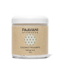 Bottle of Paavani Ayurveda Coconut Milk Bath with herbal ingredients for skin and spiritual wellness in a simple, natural setting