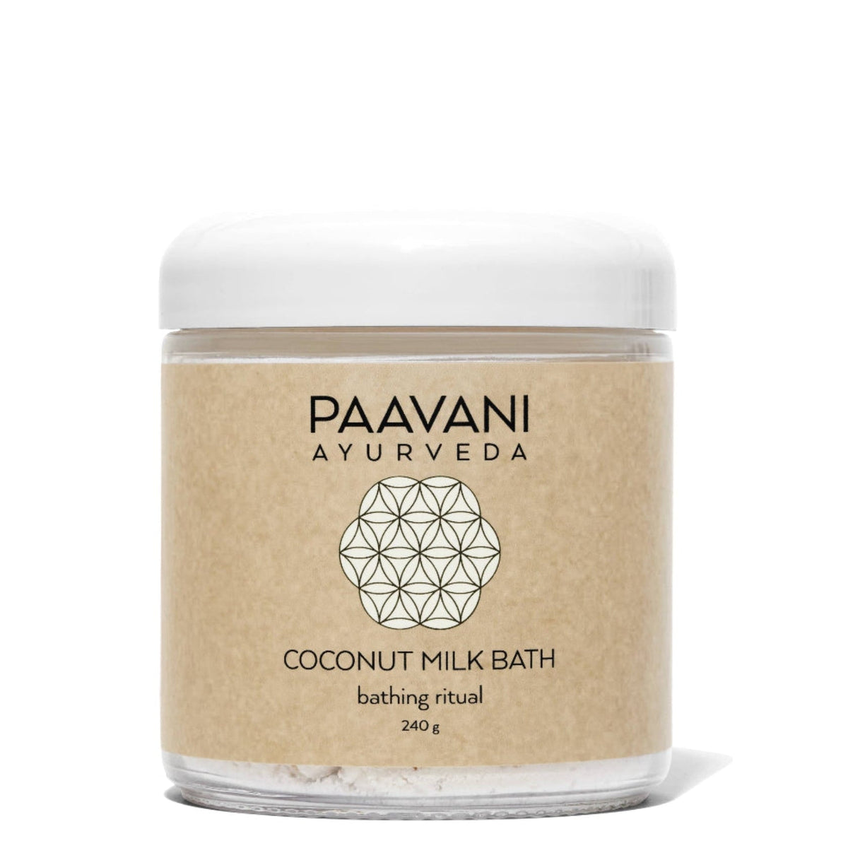 Bottle of Paavani Ayurveda Coconut Milk Bath with herbal ingredients for skin and spiritual wellness in a simple, natural setting